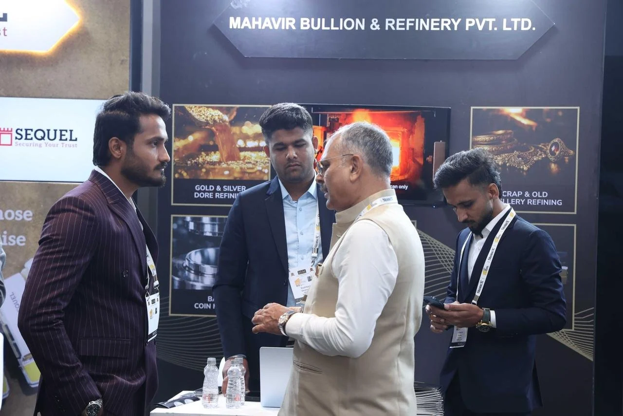 Visitors speaking at the Mahavir booth at IIBS
